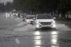 Personas se movilizan en vehículos por una avenida inundada este viernes, en Santo Domingo (República Dominicana). EFE/Orlando Barría