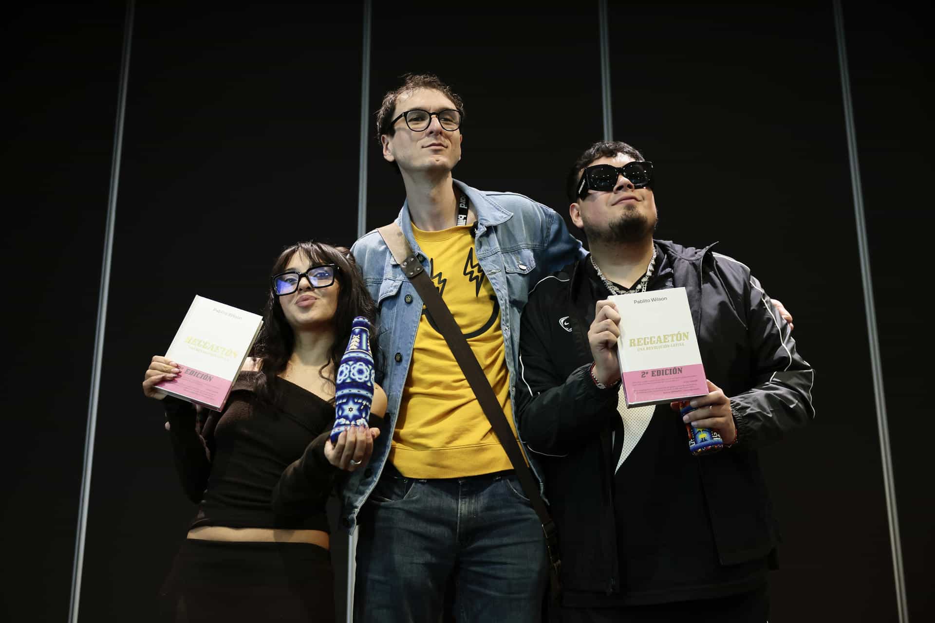 El periodista y escritor argentino Pablito Wilson (c), posa junto a los cantantes mexicanos Cachirula (i), y Loojan durante el conversatorio Flow-Fest como fenómeno cultural realizado este viernes, en la Ciudad de México (México). EFE/José Méndez