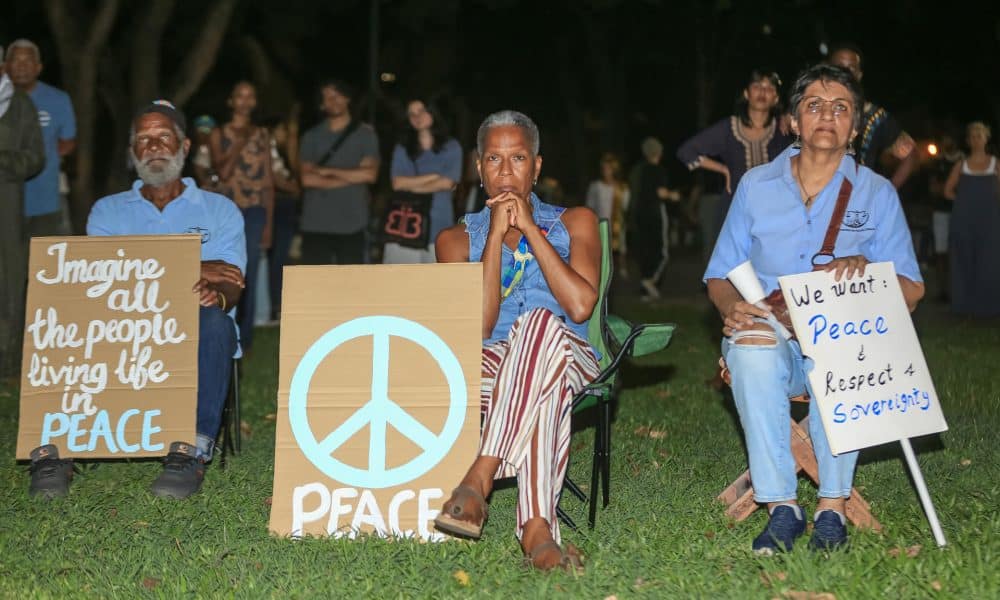 Fotografía del 09 de noviembre de 2025 que muestra a personas sosteniendo carteles durante una 'Vigilia por la Paz' en la plaza Woodford, en Puerto España (Trinidad y Tobago). EFE/ Andrea De Silva