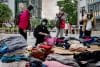 HONG KONG (China), 27/11/2025.- Displaced residents from an apartment fire in Tai Po district collect donated clothing in Hong Kong, China, 27 November 2025. The fire, which started on 26 November, has killed at least 44 people, and left 279 missing. EFE/EPA/LEUNG MAN HEI