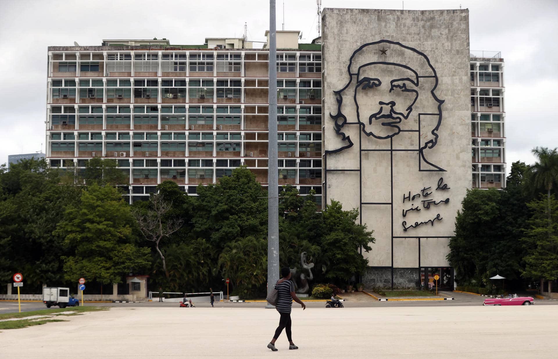 Una mujer camina frente al edificio del Ministerio del Interior de Cuba (Minint) con la imagen del guerrillero argentino-cubano Ernesto 'Ché' Guevara este viernes, en la plaza de la Revolución en La Habana (Cuba). EFE/ Ernesto Mastrascusa