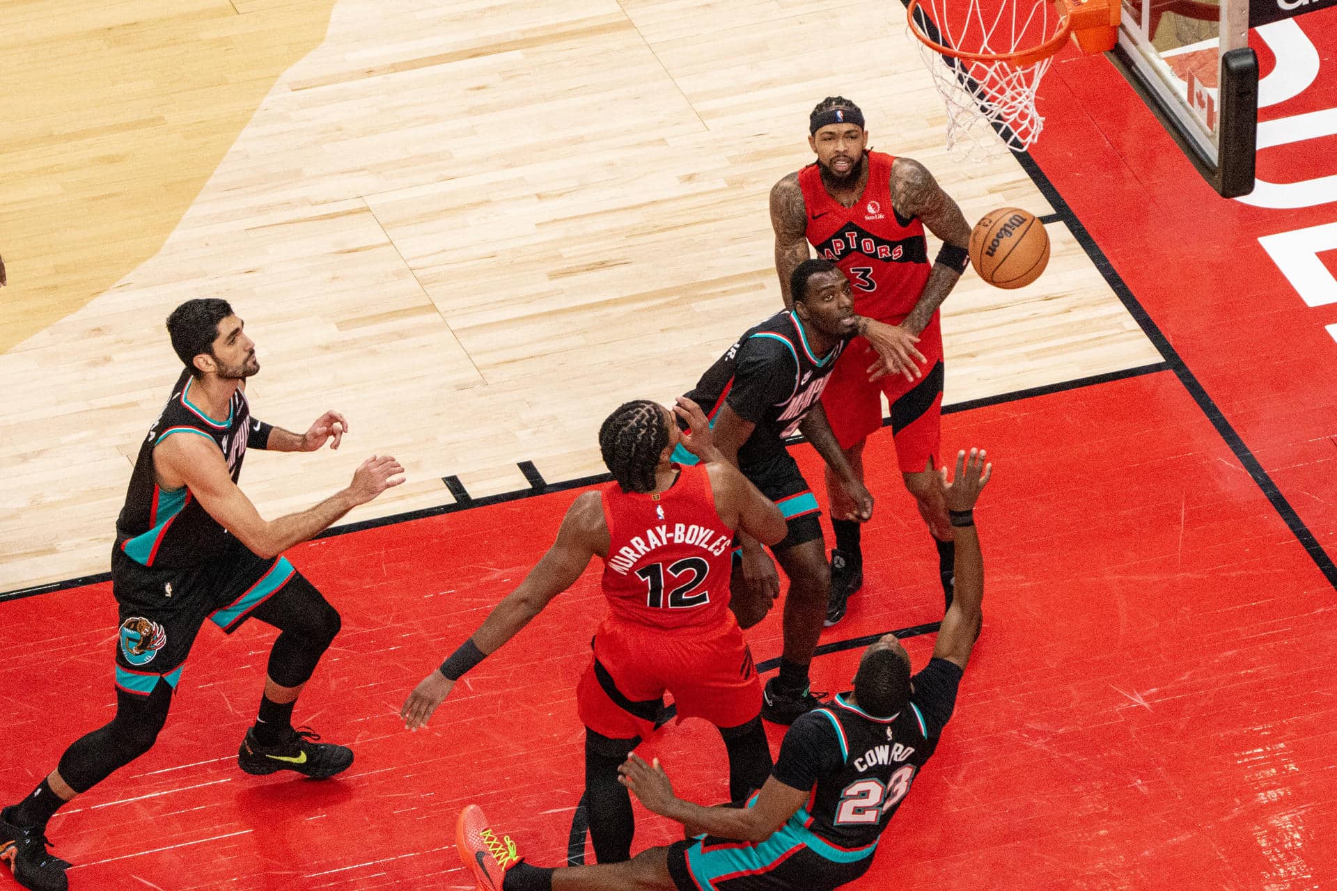 Collin Murray-Boyles (c) de los Raptors, disputa un balón con Cedric Coward, de Grizzlies de Memphis, este domingo durante un juego de la NBA en Toronto. EFE/ Julio Cesar Rivas