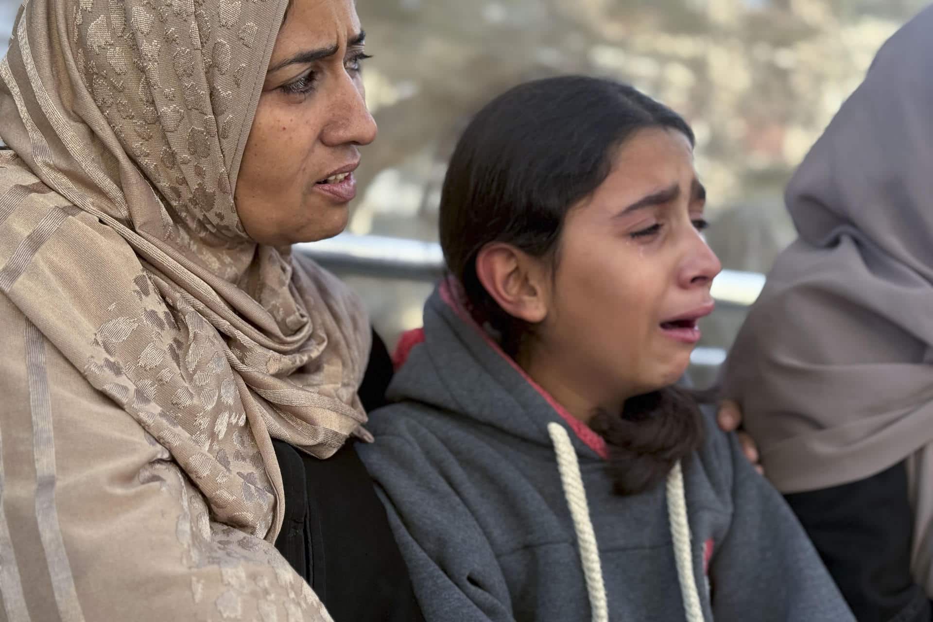 Familiares lloran en el hospital Al Shifa donde fueron trasladadas las víctimas en la ciudad de Gaza. Israel mató, durante la oleada de bombardeos de este miércoles, a 32 gazatíes -entre ellos 12 niños- e hirió a otros 88, según los datos difundidos este jueves por el Ministerio de Sanidad de la Franja de Gaza. 
EFE/ Ahmad Awad