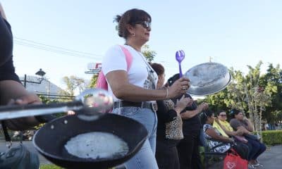 Personas participan de una protesta denominada 'Cacerolazo por otra Navidad Negra' este sábado, en San Salvador (El Salvador). Una veintena de activistas salvadoreños protestó contra los despidos arbitrarios de personal del sistema de salud gubernamental denunciados esta semana y señalaron que las denuncias de ceses de trabajadores estatales en 2025 suman más de 22.000 EFE/ Javier Aparicio