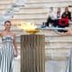 La actriz griega Mary Mina, en el papel de la Suma Sacerdotisa, enciende la Antorcha Olímpica durante la ceremonia de entrega de la Llama Olímpica para los Juegos Olímpicos de Invierno Milano Cortina 2026, en el Estadio Panatenaico de Atenas, Grecia, este jueves. EFE/ Orestis Panagiotou