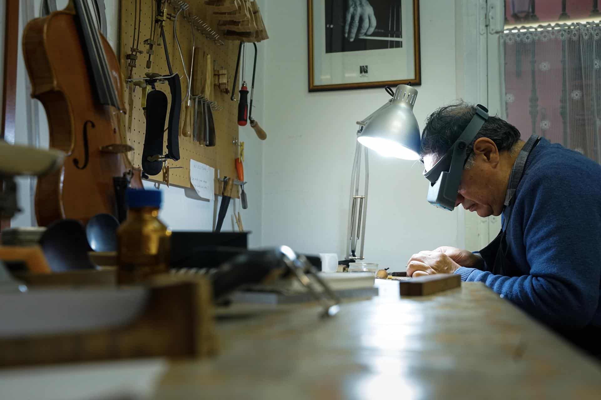 Fotografía de Francisco González, trabajando en su taller de arquetería, donde fabrica y arregla instrumentos musicales realizados con palo de brasil, un material en peligro de extinción. Autor: Mario Morón