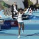 La atleta keniana Janeth Jepkosgei cruza la línea de meta para ganar la carrera de la 45ª Maratón de Valencia. EFE/Kai Forsterling