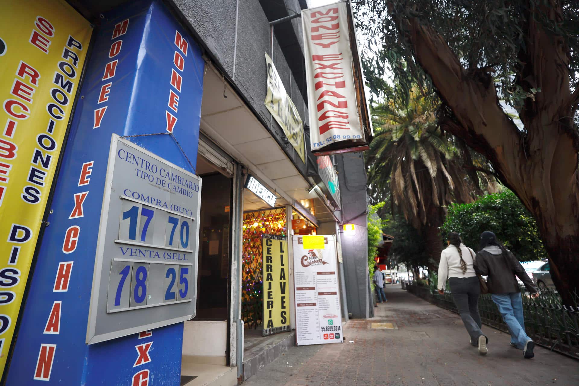 Personas caminan frente a una casa de cambio este lunes, en Ciudad de México (México). EFE/ Sáshenka Gutiérrez