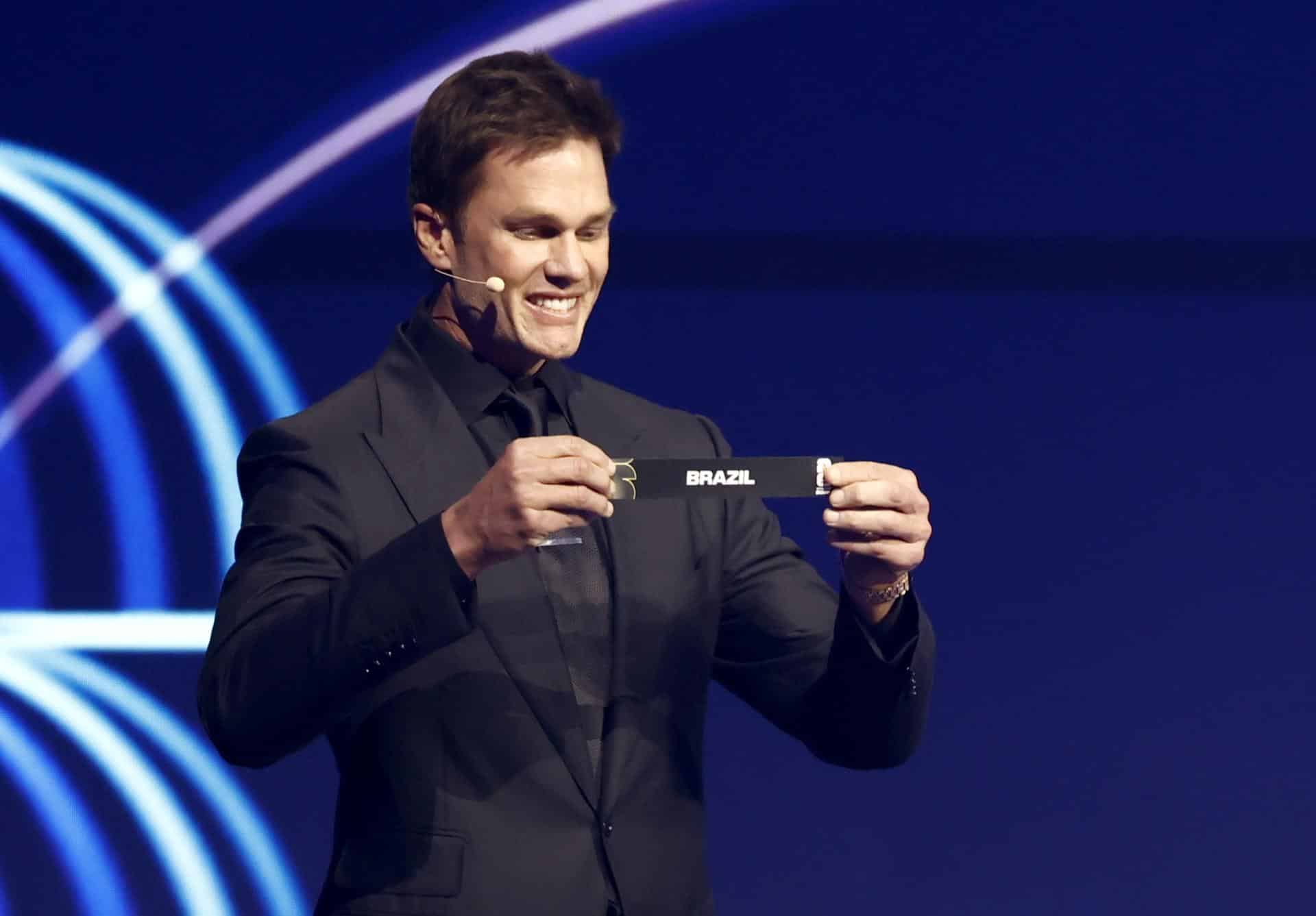 El asistente de sorteo Tom Brady sostiene el boleto de Brasil mientras se sortean los grupos de las naciones semilladas durante el sorteo final de la Copa Mundial de la FIFA 2026. EFE/EPA/WILL OLIVER