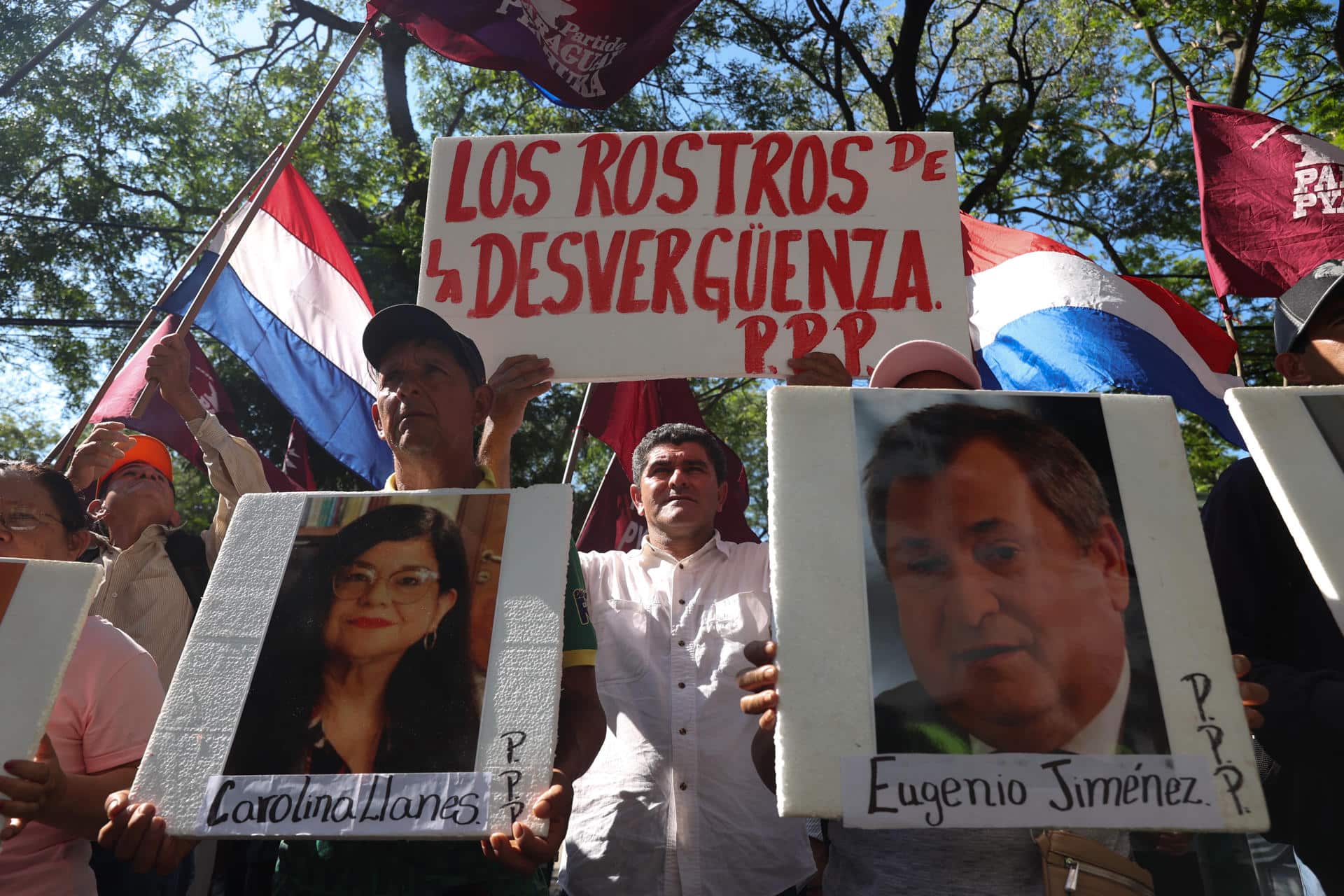 Personas sostiene carteles con la imagen de los ministros de la Corte Suprema de Justicia Carolina LLanes (i) y Eugenio Jiménez durante una manifestación este lunes, en Asunción (Paraguay). EFE/ Juan Pablo Pino
