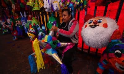 Una vendedora sostiene una piñata en el mercado de Jamaica, en Ciudad de México (México). Imagen de archivo. EFE/ Sáshenka Gutiérrez