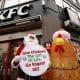 TOKYO (Japan), 03/12/2025.- Wearing a Santa Claus costume, an animal rights activist of People for the Ethical Treatment of Animals (PETA) stands next to an inflatable chicken in front of a KFC fast food restaurant in Tokyo, Japan, 03 December 2025. In a statement, PETA said it is protesting against cruelty on chickens reported at a KFC supplier in Japan. (Protestas, Japón, Tokio) EFE/EPA/FRANCK ROBICHON