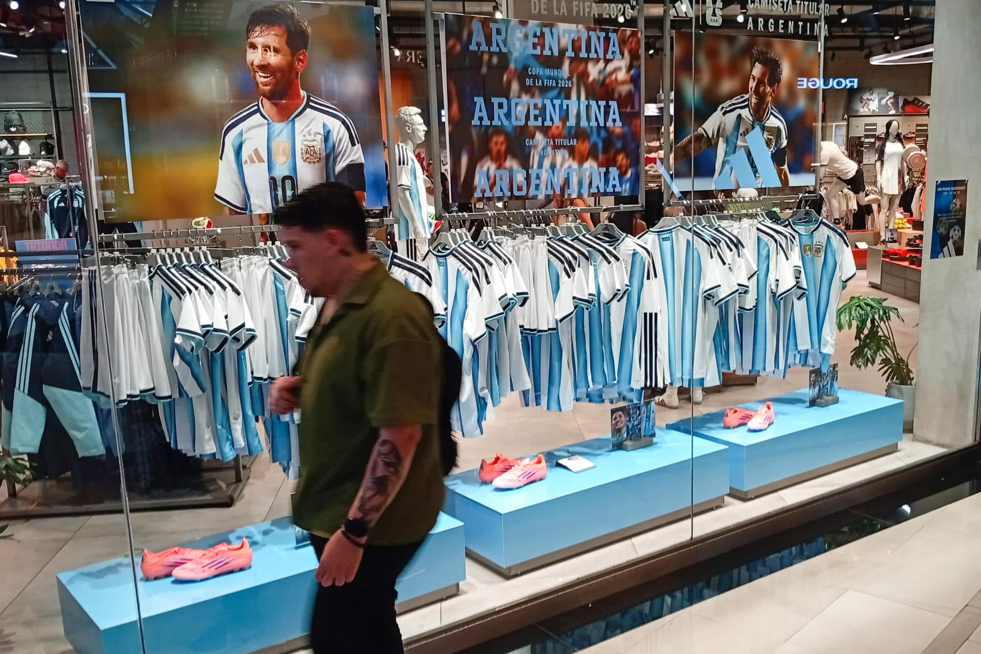 Una persona camina frente a una vitrina con camisetas de la selección de fútbol Argentina en el centro de Buenos Aires (Argentina). EFE/ Matias Martin Campaya