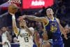 El escolta de los Milwaukee Bucks Ryan Rollins (i) va a la canasta para dos puntos mientras el alero de los Golden State Warriors Gui Santos (d) y el escolta de los Golden State Warriors De'anthony Melton (c) defienden durante la primera mitad del partido de baloncesto de la NBA entre los Milwaukee Bucks y los Golden State Warriors en San Francisco, California (EE.UU.). EFE/JOHN G. MABANGLO SHUTTERSTOCK OUT