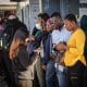 Migrantes haitianos hacen fila afuera de la Agencia de la ONU para los Refugiados (ACNUR) para solicitar apoyo de regularización de documentos este sábado, en la ciudad de Tijuana (México). EFE/Joebeth Terríquez
