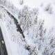 Un coche conduce por una carretera que discurre entre un bosque cubierto de nieve, cerca de Filzmoos (Austria), en una imagen de archivo. EFE/ Christian Bruna