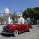 Turistas pasean en un auto clásico cerca del Capitolio de La Habana en La Habana (Cuba). EFE/ Ernesto Mastrascusa