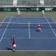 En la parte inferior, los dominicanos Peter Bertrán (c-d) y Nick Hardt (i) abren una nueva ofensiva en el partido de dobles de la serie de Copa Davis que ganaron este sábado a los letones Robert Strombachs y Karlis Ozolins. EFE/Orlando Barría