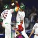 Estevan Florial (i) y Luis Roberto Verdugo (c) de México Verde celebran una anotación este jueves, durante un partido de la Serie del Caribe de Béisbol 2026 entre República Dominicana y México Verde, en el Estadio Panamericano Charros de Jalisco en Guadalajara (México). EFE/ Francisco Guasco
