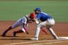 Junior Lake (i) de los Leones del Escogido de República Dominicana se barre a primera base ante Yohandy Morales, de los Cangrejeros de Santurce de Puerto Rico este lunes durante el juego de la segunda jornada de la Serie del Caribe de Béisbol en el Estadio Panamericano de Guadalajara. EFE/ Francisco Guasco