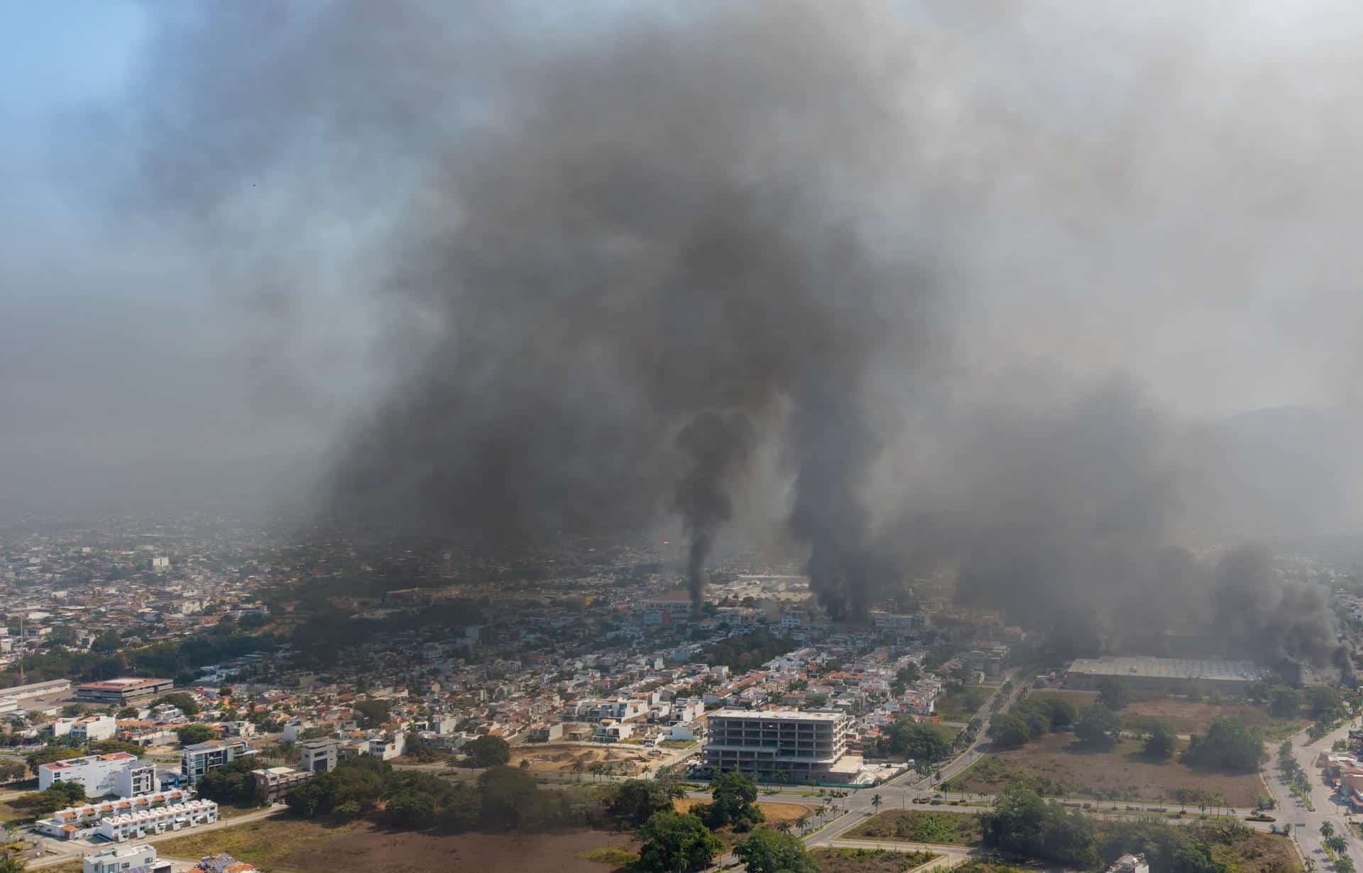 Fotografía aérea donde se ven columnas de humo tras reacciones violentas por el abatimiento de Nemesio Rubén Oseguera Cervantes, alias El Mencho, líder del Cártel Jalisco Nueva Generación (CJNG) este domingo, en Puerto Vallarta (México). EFE/ STR