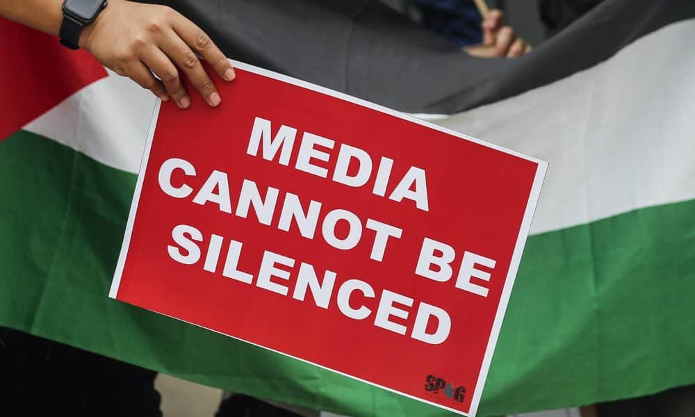 Un cartel en el que se lee, en inglés, "los medios no pueden ser silenciados", durante un acto de protesta en solidaridad con los miembros de la prensa de Gaza. EFE/ Fazry Ismail