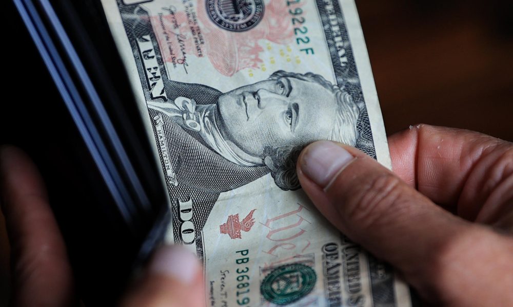 Una persona sostiene un billete de 10 dolares. Imagen de archivo. EFE/ José Jácome