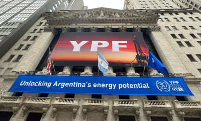 Fotografía de archivo que muestra la bandera de Estados Unidos y la bandera de Argentina mientras ondean encima de una enrome pancarta de la petrolera argentina YPF en la fachada de la bolsa de valores de Nueva York. EFE/Sarah Yáñez-Richards
