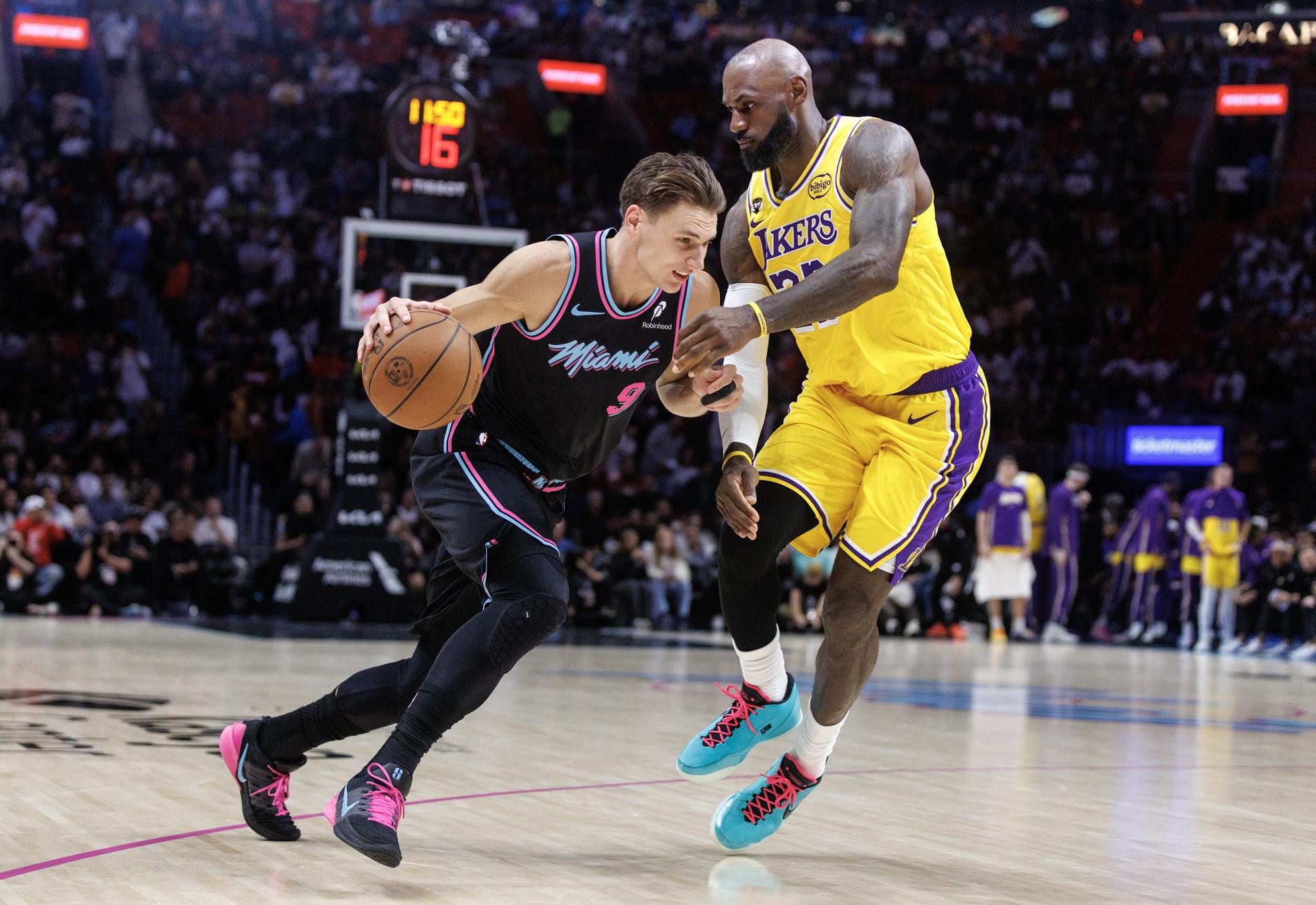 Pelle Larsson (i), del Miami Heat, en acción contra LeBron James, de los Lakers, quien igualó el récord de 1.611 partidos disputados en la NBA por Robert Parish. EFE/EPA/CRISTOBAL HERRERA-ULASHKEVICH SHUTTERSTOCK OUT