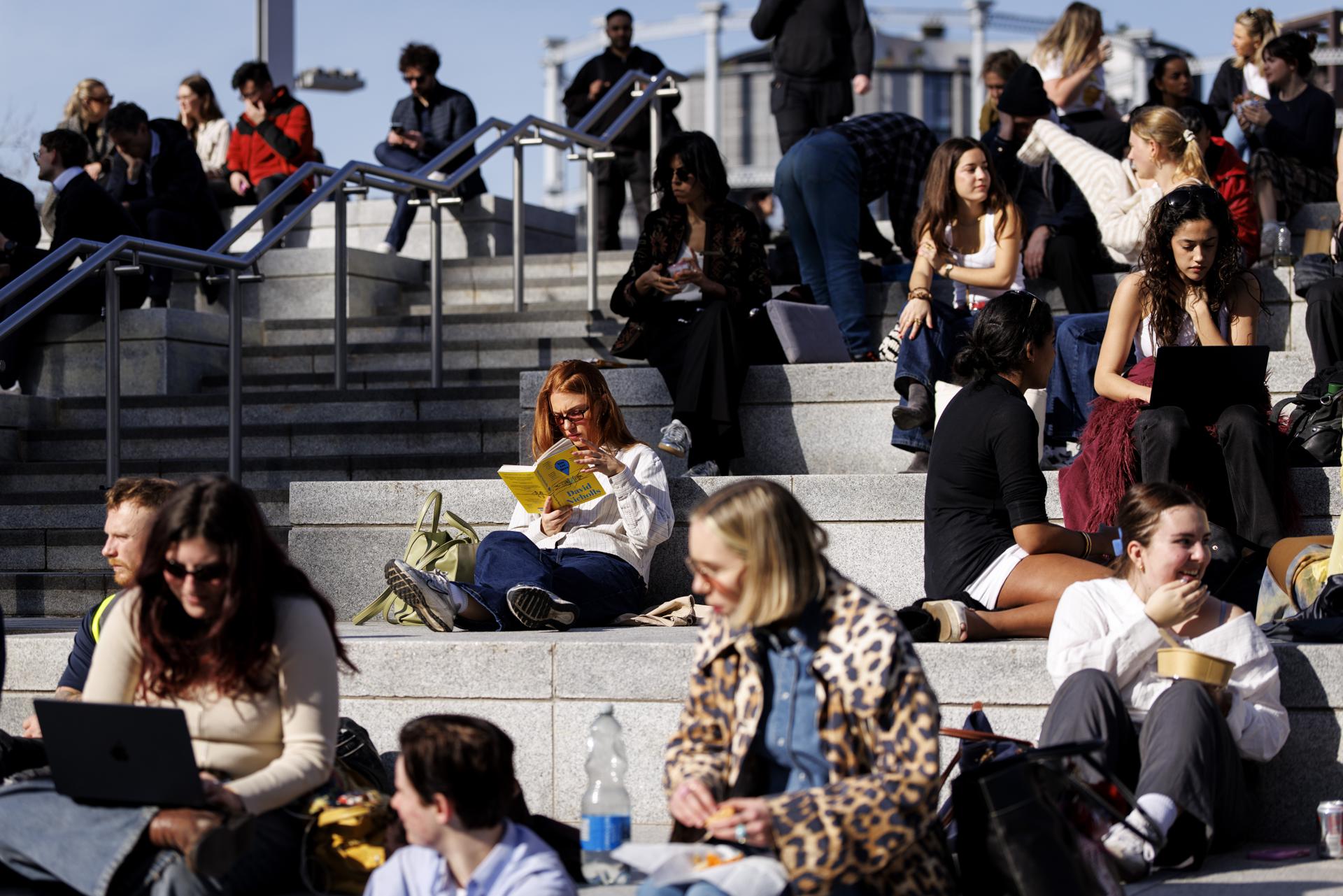 La gente disfruta del cálido sol durante el almuerzo en Regent's Canal, cerca de King's Cross, Londres, Gran Bretaña, el pasado febrero. EFE/ Tolga Akmen