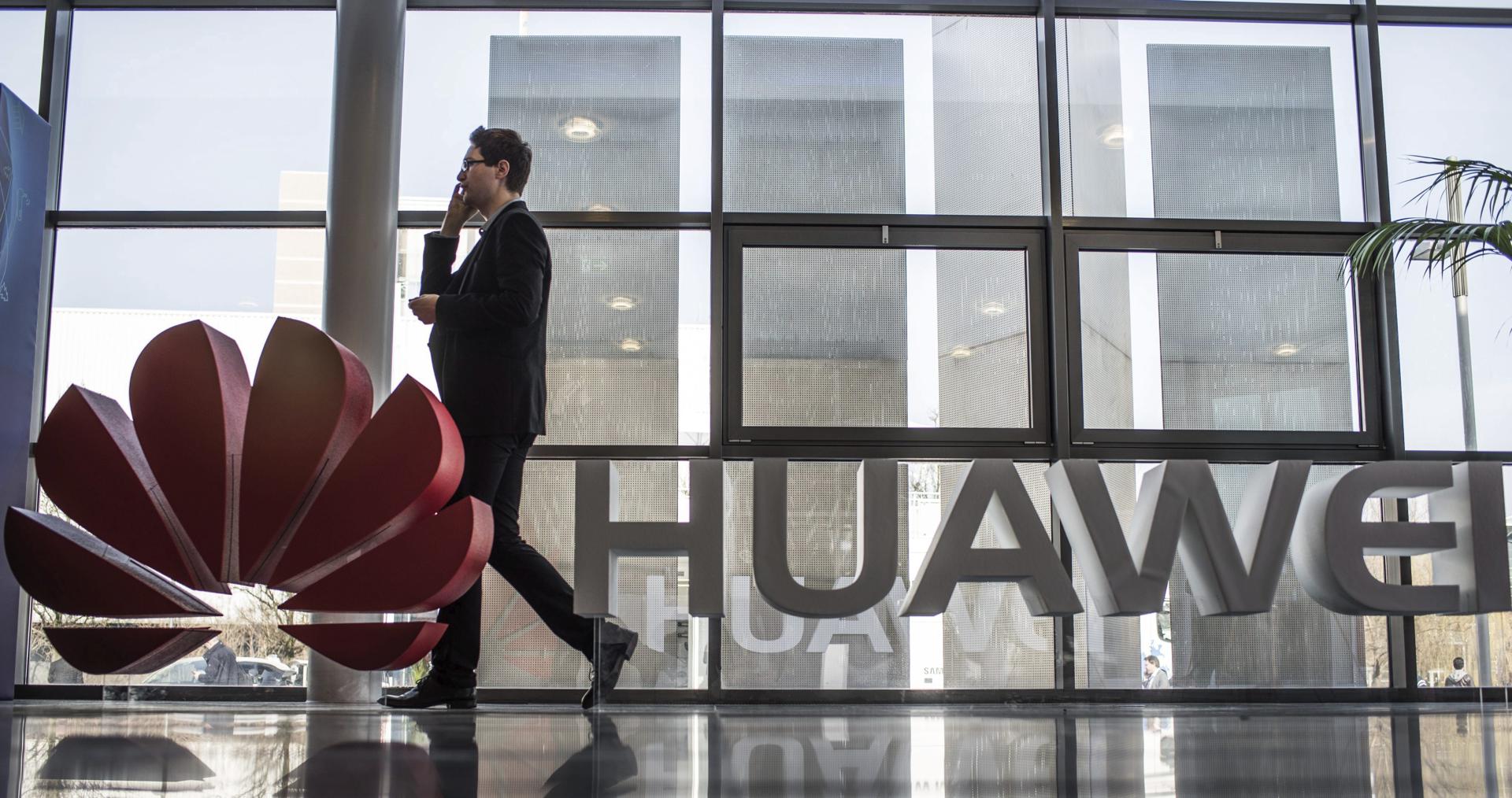 Fotografía de archivo que muestra a un hombre junto al logotipo de Huawei en la feria CeBIT en Hanover (Alemania). . EFE/Ole Spata