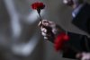 Una persona sostiene un clavel rojo durante la ceremonia de conmemoración de la Revolución de los Claveles del 25 de Abril en el Parlamento de Lisboa. EFE/EPA/RODRIGO ANTUNES

