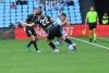 El delantero del Celta de Vigo Ferran Jutglà (d) lucha por el balón con el defensa David Affengruber (c), del Elche, durante el partido de LaLiga disputado este domingo en el Estadio Abanca-Balaídos de Vigo. EFE/ Salvador Sas
