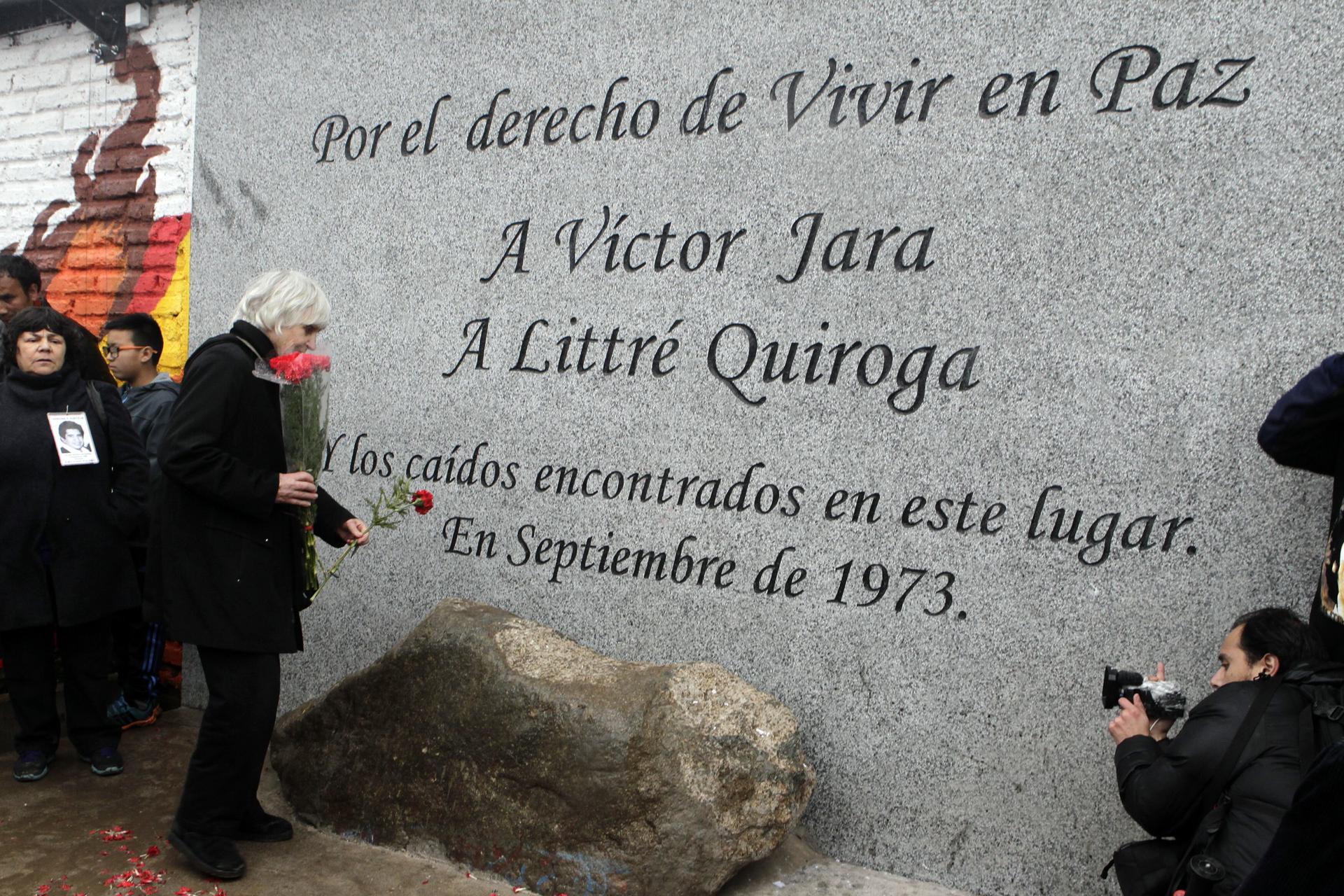 Fotografía de archivo, tomada el 13 de septiembre de 2014, en la que se captó a la viuda del cantautor chileno Víctor Jara, Joan Jara (3-i), durante la inauguración del memorial en homenaje al legendario artista chileno, en las afueras del Cementerio Metropolitano de Santiago de Chile (Chile). EFE/Sebastián Silva