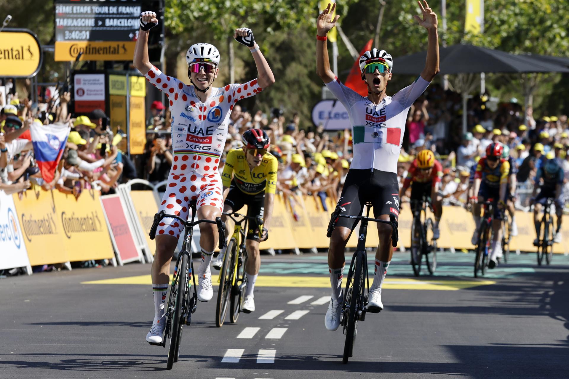 El ciclista mexicano Isaac del Toro (d), del equipo UAE Team Emirates XRG, celebra la victoria junto a su compañeo de equipo el esloveno Tadej Pogacar, en la segunda etapa del Tour,con final en Barcelona. EFE/EPA/YOAN VALAT