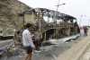 - Personas se encuentran cerca de un autobús incendiado en el lugar de los enfrentamientos en el paso fronterizo de Bab Sebta, cerca de Fnideq, Marruecos, el 31 de julio de 2026. Los disturbios estallaron cuando miles de migrantes intentaron cruzar a Ceuta y se enfrentaron a las fuerzas de seguridad marroquíes. (Marruecos) EFE/EPA/JALAL MORCHIDI
