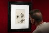 Un visitante observa una obra en el Museo Dalí en jornada nocturna, 'Dalí, nit i subconscient', en la que la voz y rostro del genio surrealista cobran presencia para acompañar al público en la localidad gerundese de Figureres. EFE/David Borrat.
