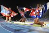 Liranyi Alonso (c), de República Dominicana, medalla de oro; Gladymar Torres, de Puerto Rico, medalla de Plata, y Yarima García, de Cuba, medalla de bronce, reaccionan luego de la final de los 100 metros femenino durante los XXV Juegos Centroamericanos y del Caribe Santo Domingo 2026, en Santo Domingo (República Dominicana). EFE/ Orlando Barría